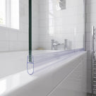 Clear seal running the full width of a bath screen bottom edge, teardrop bubble on the white bath