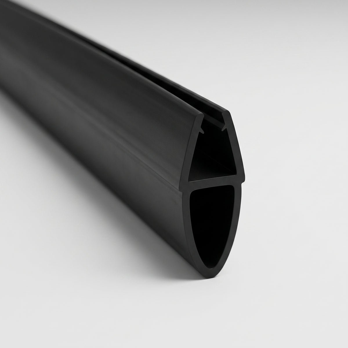 Length of black shower seal on white, glass channel above a tall oval hollow bubble