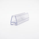 Cut length of clear carrier seal on white, angled view - sloped glass channel over a slotted base track