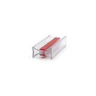 Clear bow-tie I-join seal offcut on white, red 3M tape strip pressed into its centre channel
