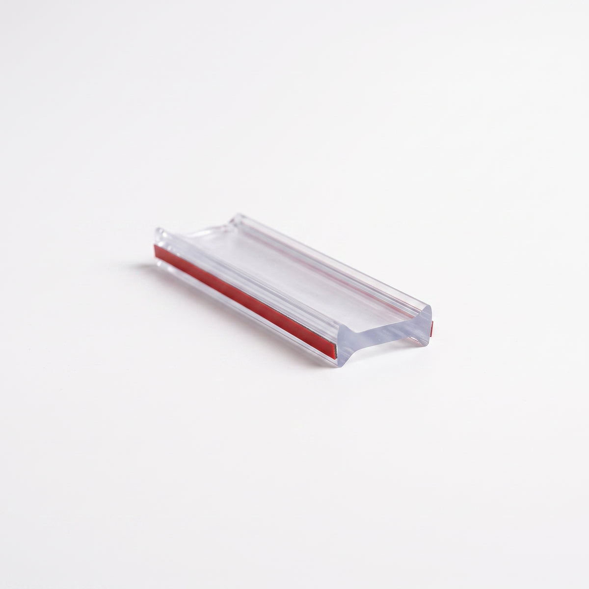 Clear I-join seal offcut on white, bow-tie section with a red 3M tape liner along one face