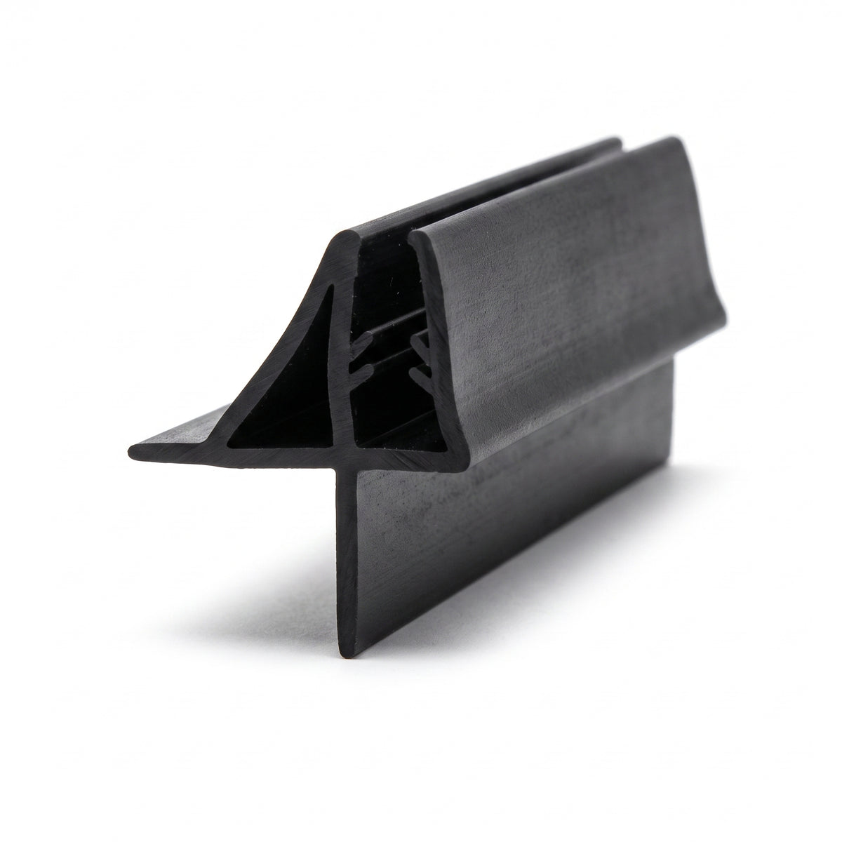 Black seal offcut on white at an angle, glass channel between a raised deflector fin and a flat lower fin