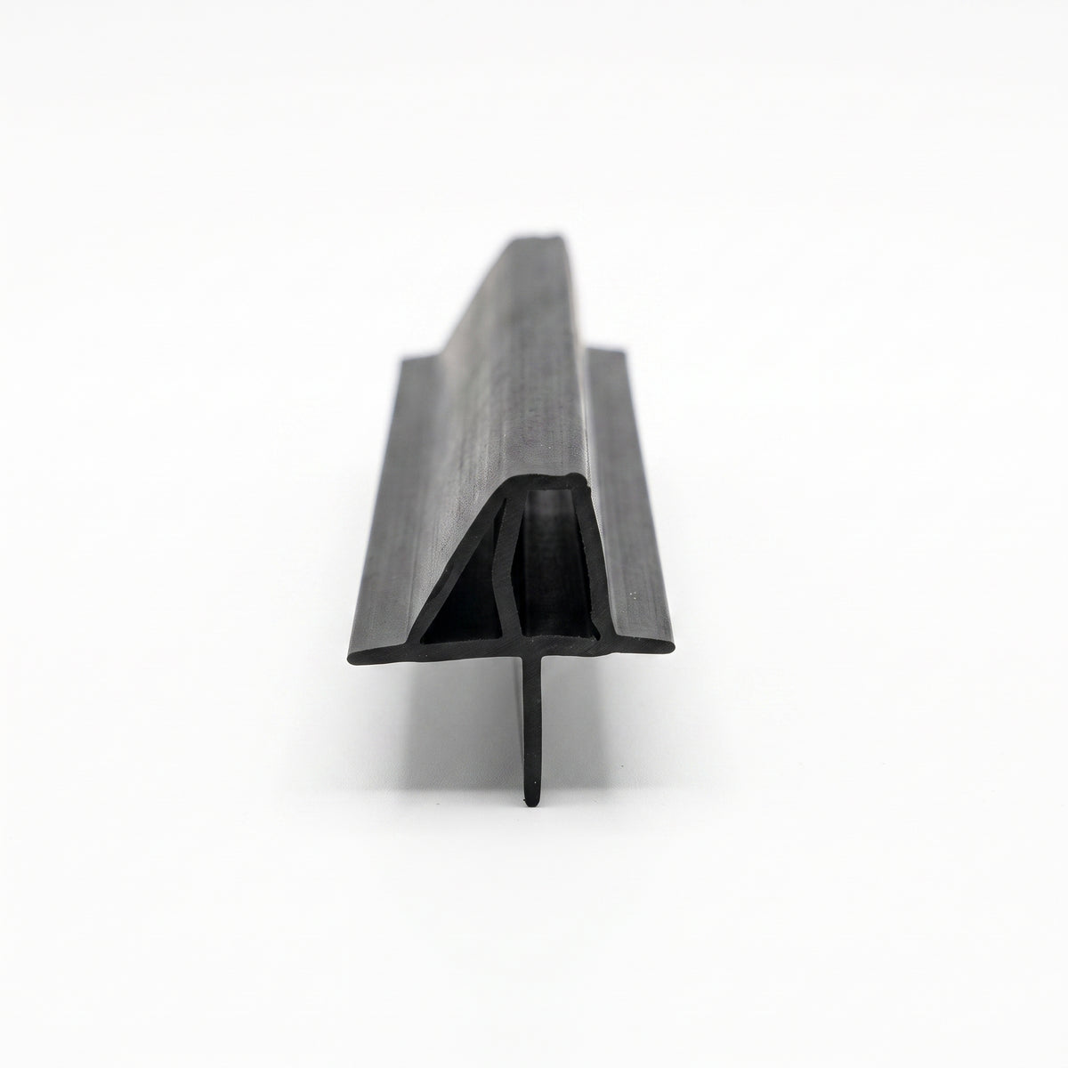 Length of black shower seal on white, channel with an upper wing fin and a lower drop blade