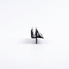 Black seal offcut end-on on white, channel with a sweeping wing above a straight drop fin