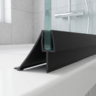 Black seal with a wide sweeping deflector and straight fin on a glass screen edge, over a white bath