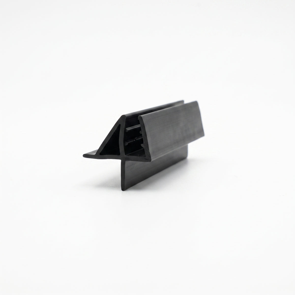 Short black seal offcut on white, glass channel between a triangular deflector and a flat lower fin