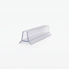 Cut length of clear shower seal on white, angled - glass channel on two splayed triangular legs