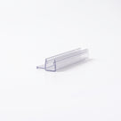 Clear seal offcut on white at an angle, glass channel with a short bead-tipped side fin