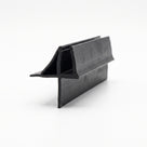 Black seal offcut on white at an angle, channel with an angled fin above a flat lower skirt