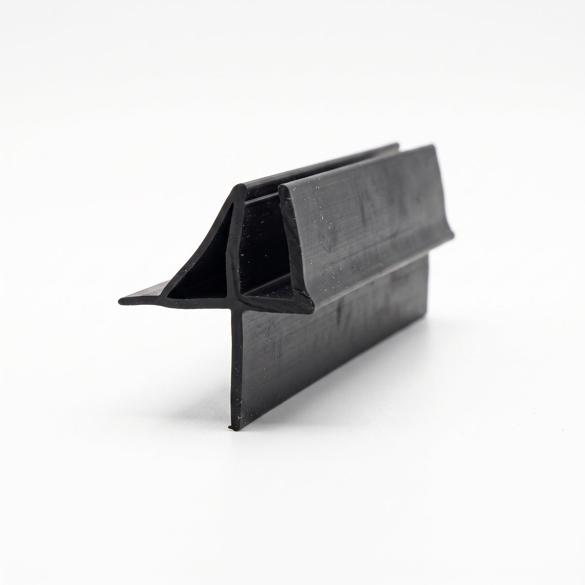 Black seal offcut on white at an angle, channel with an angled fin above a flat lower skirt