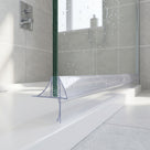 Clear seal on a green-edged glass screen above a white tray, long blade angled down to the tiled floor