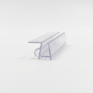 Cut length of clear shower seal on white, angled - flat top fin above a channel with a small base bubble