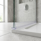 Clear seal along the foot of a glass screen on a white tray, curved underseal outlined in blue at the near end