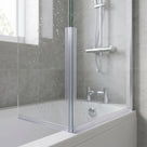 Clear twin-channel corner seal joining two 4-5mm glass bath screen panels at a 90 degree joint over a bath