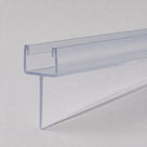 Clear PVC tapered seal profile on pale grey, U-channel top with the soft fin sloping away along its length