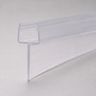 Clear PVC tapered seal profile on pale grey, U-channel top with the soft fin sloping away along its length