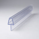 Clear PVC tapered seal profile angled on pale grey, trapezoid channel above a stem and sloping fin