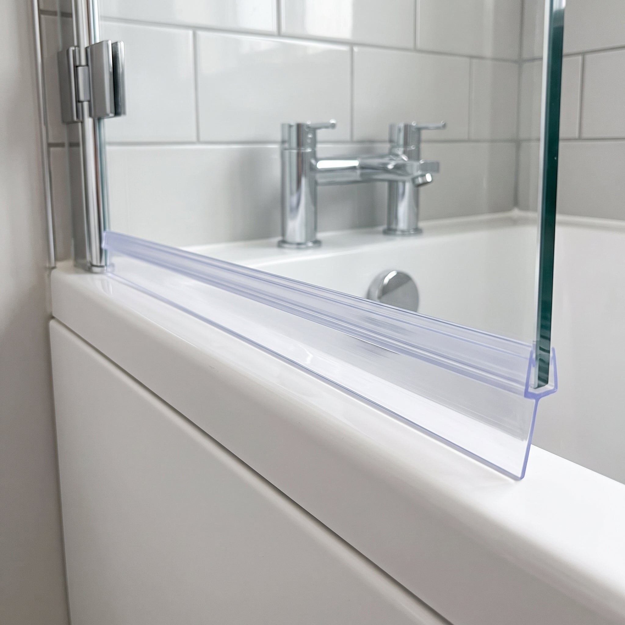 Clear tapered shower seal on 6-8mm bath screen glass, fin tapering from 10mm to 2mm to seal an uneven gap