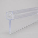 Clear PVC tapered seal profile on pale grey, rounded channel with gripping nibs above a sloping fin