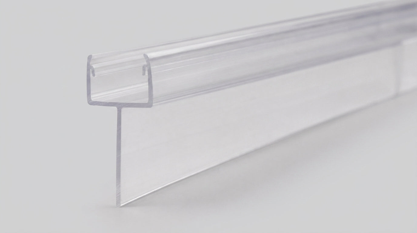 Studio shot of the tapered shower seal profile - clear PVC U-channel with fin tapering from 20mm to 10mm along its 900mm length