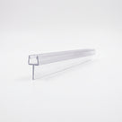 Short section of clear tapered seal lying on white, narrow channel above a slim flat fin