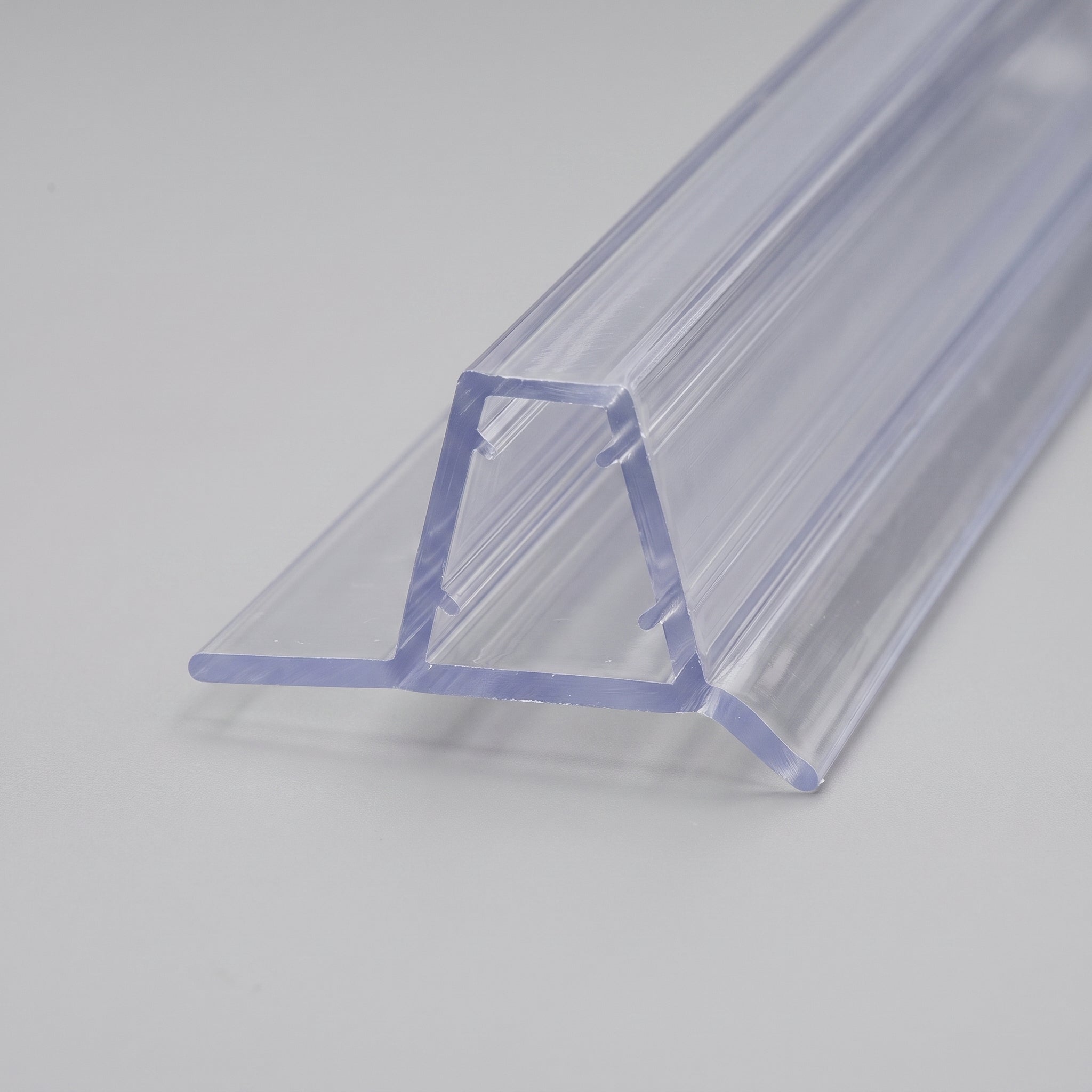 Studio shot of the clear seal profile - 12mm PVC U-channel with a 7mm soft base flap and 6mm angled drip fin