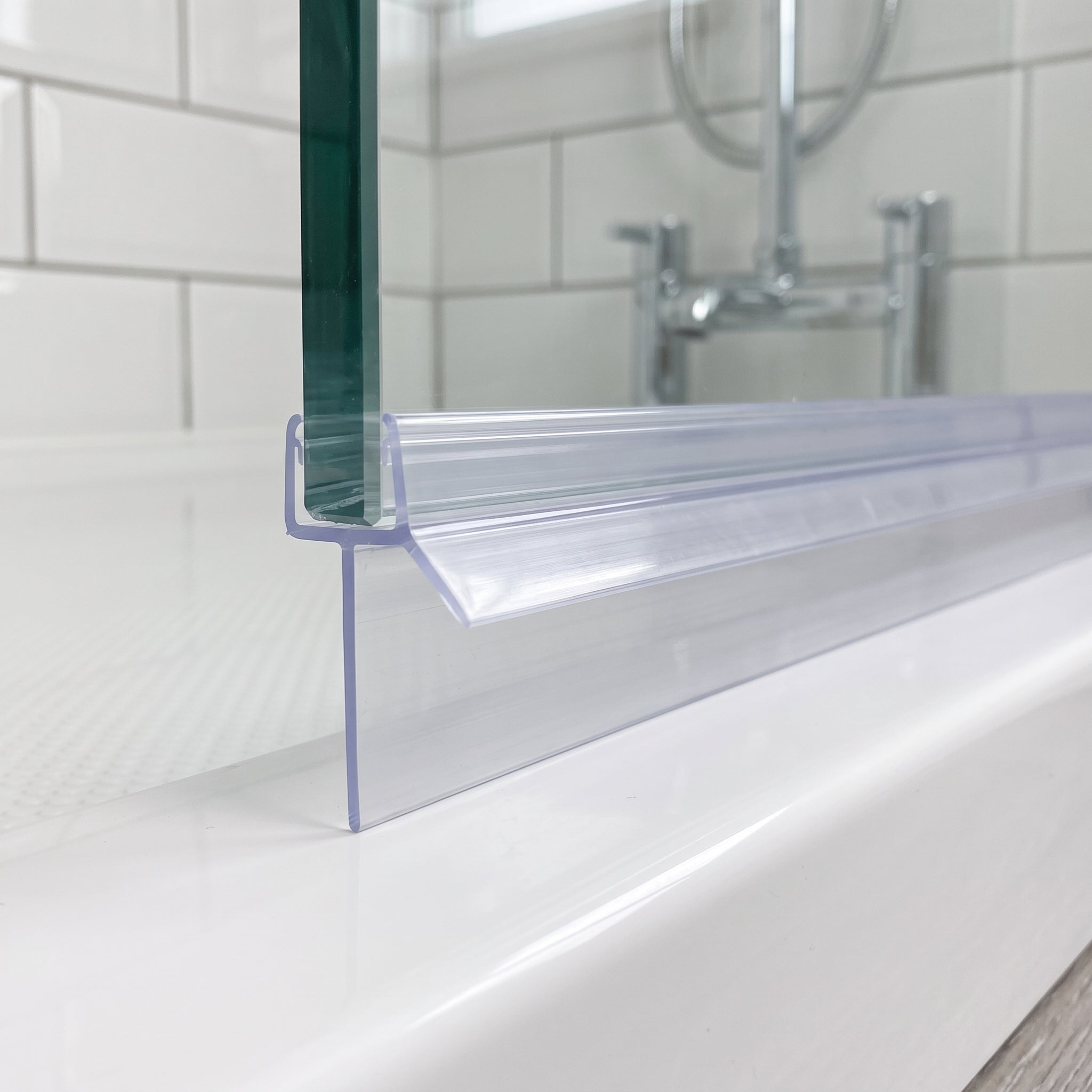 Clear SEAL195 seal on a 6-8mm glass door bottom edge - 23mm fin closing a large gap to the tray