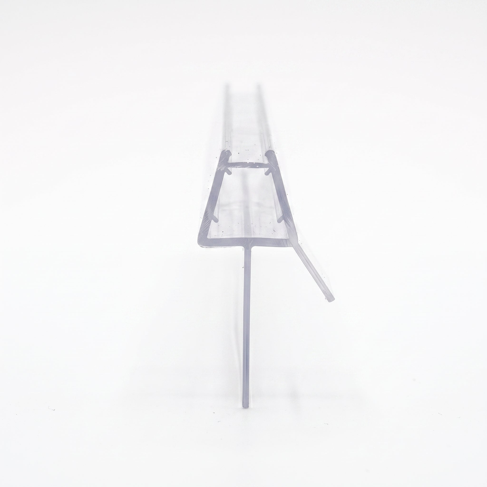 Cut length of SEAL196 clear shower screen seal - trapezoid channel for 6-8mm glass with 26mm blade and angled fin for 22-26mm gaps