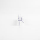 Small clear seal offcut on white, end-on - glass channel with a straight drop fin and a short diagonal fin