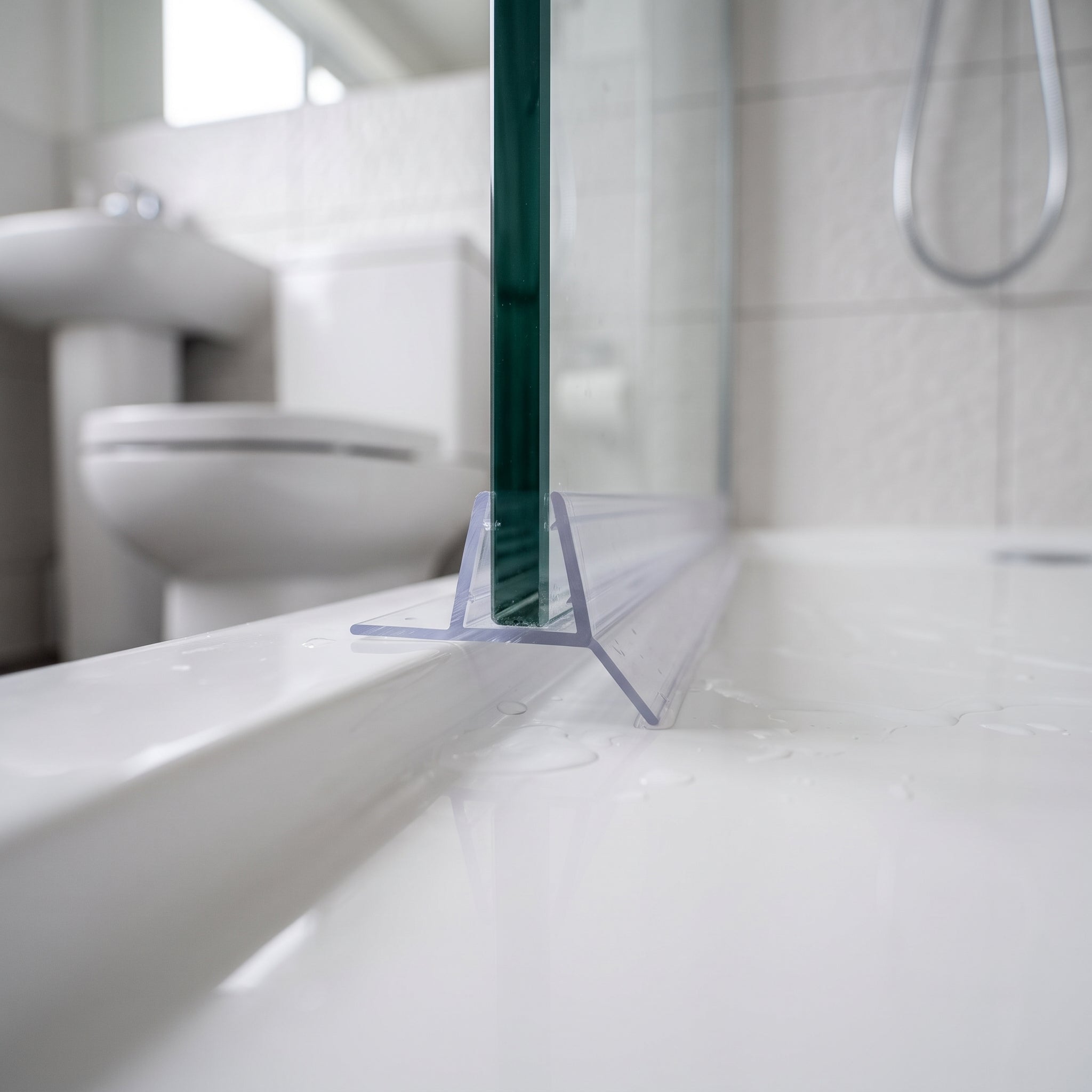 SEAL313 clear bottom seal on 4-6mm shower door glass - twin fins deflecting water back into the tray