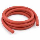 Brick-red silicone cord in three loose coils on white, matte finish, round cut ends at the front and right