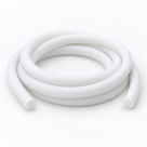 Matte white silicone cord lying in three loose coils on a pale grey ground, round cut ends facing forward