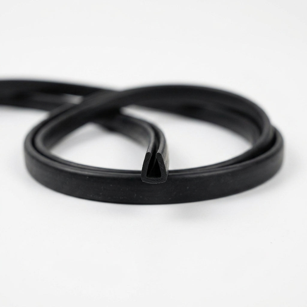 Length of black rubber U-channel edge seal U006 coiled on a white background, cut end showing the 5mm x 10mm U profile