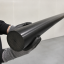 Black UHMWPE rod held by a gloved hand, tapered perspective view