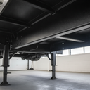 Vehicle chassis freshly painted black underbody protective coating in UK workshop