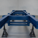 Vehicle chassis freshly painted blue underbody protective coating in UK workshop