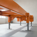 Vehicle chassis freshly painted orange underbody protective coating in UK workshop