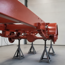 Vehicle chassis freshly painted post office red underbody protective coating in UK workshop