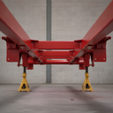 Vehicle chassis freshly painted red underbody protective coating in UK workshop