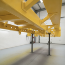 Vehicle chassis freshly painted yellow underbody protective coating in UK workshop